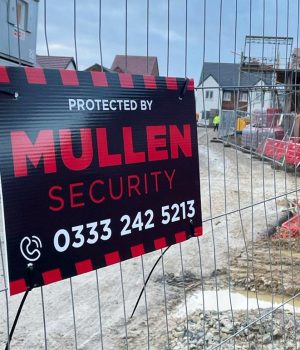Close up of Mullen Security sign on construction site fences Close up of Mullen Security sign on construction site fences