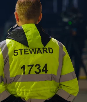 Sports match security guard with hand behind his back Sports match security guard with hand behind his back